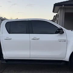 White Toyota Hilux with tinted windows