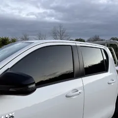 White Toyota Hilux with tinted windows