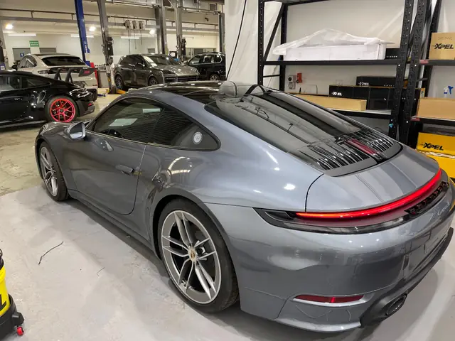 Grey Porsche 911 with tinted windows in the workshop