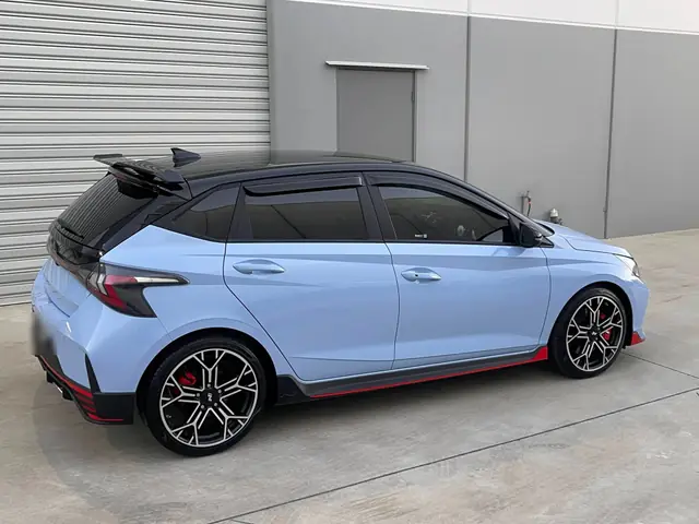Blue Hyundai hatchback with tinted windows