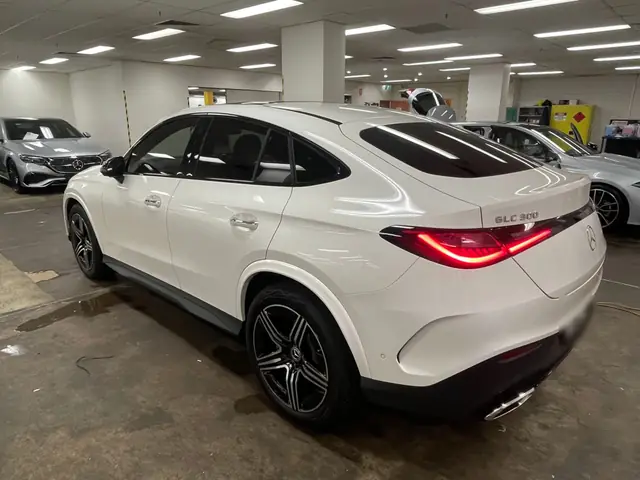 White Mercedes coupe SUV with tinted windows