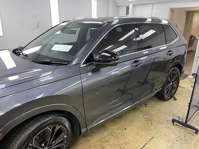 Grey SUV with tinted windows in the workshop