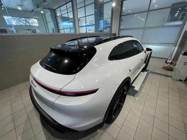 White Porsche Taycan with tinted rear windows