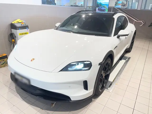 White Porsche Taycan with tinted windows